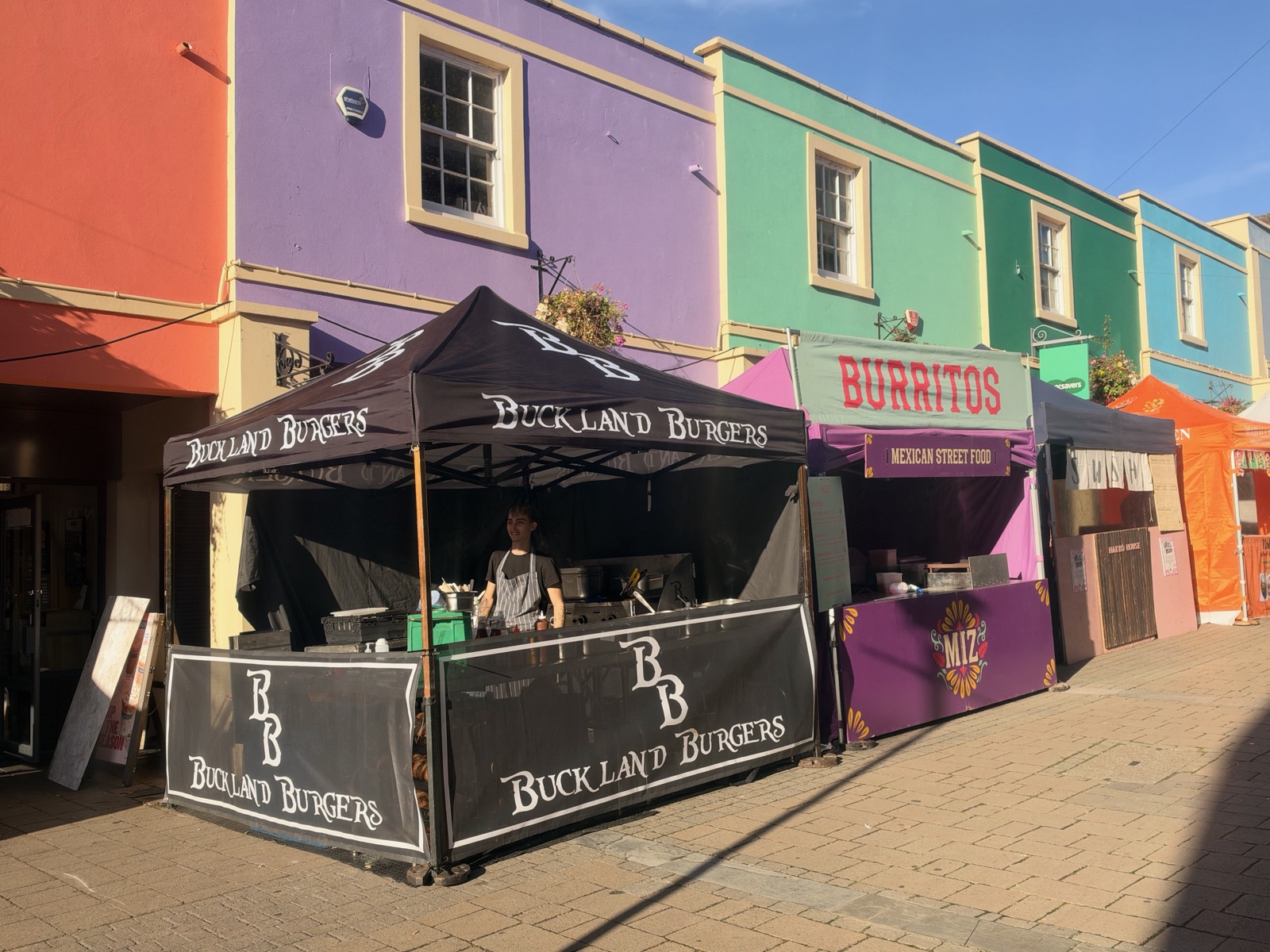 Buckland Burgers stall on a Bristol street lined with colourful houses