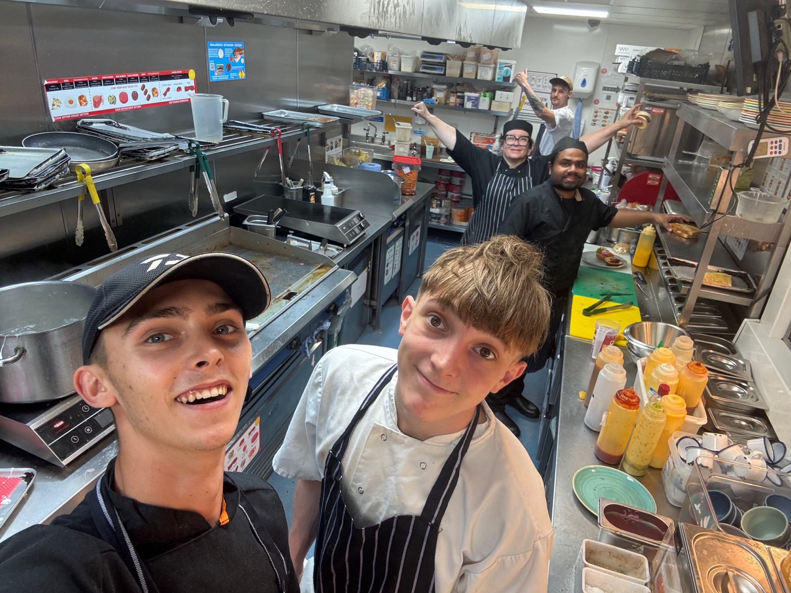 Selfie of the kitchen team on the line in a restaurant kitchen