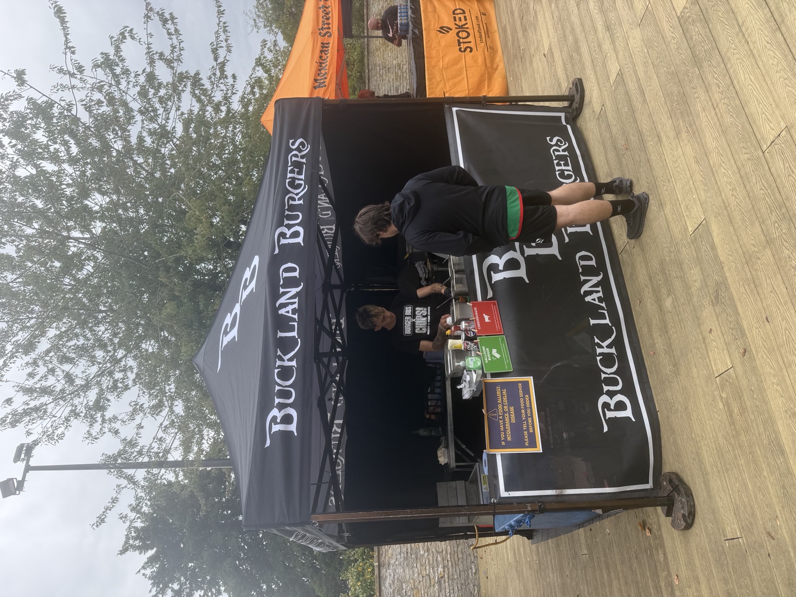 Tyler serving a customer at the Buckland Burgers gazebo