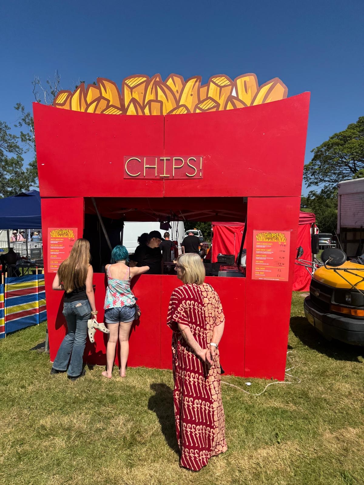 Customers queuing at a giant red chip-box food stall